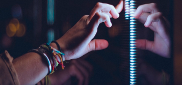 student hand touching interactive screen